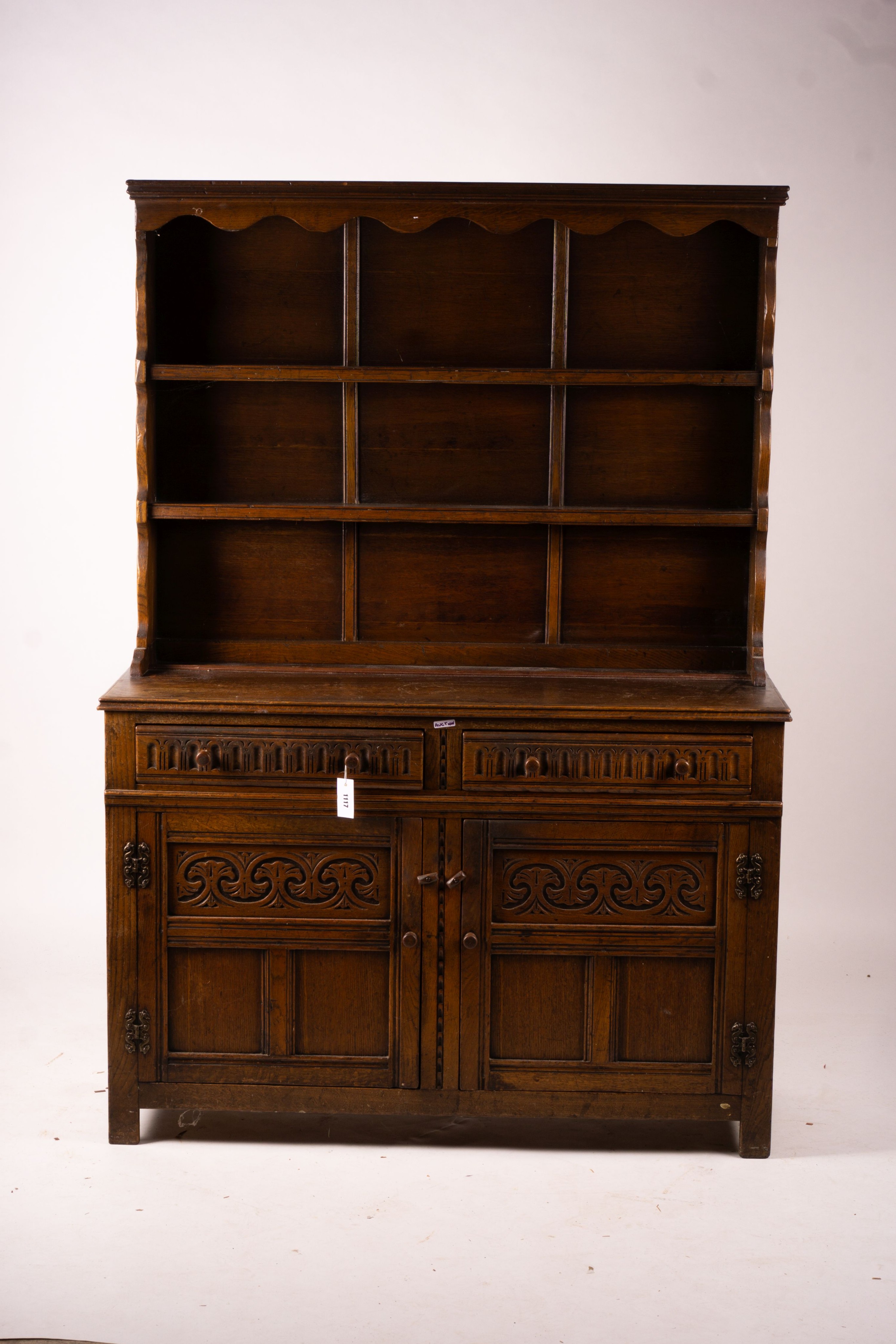 An 18th century style carved oak dresser, width 124cm, depth 46cm, height 175cm